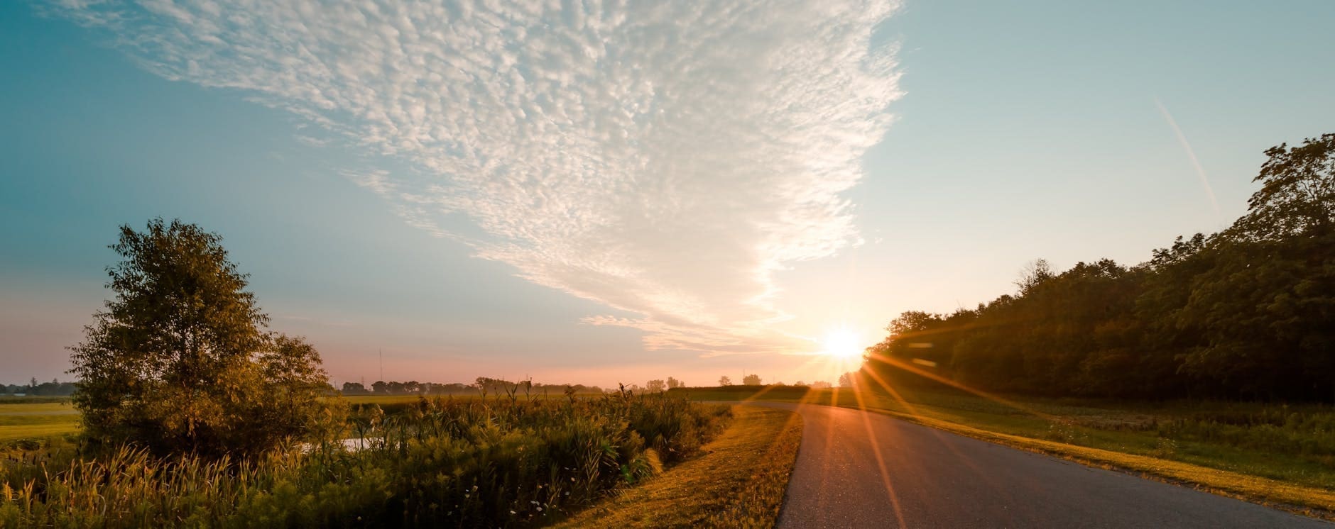 photo of road during sunrise
